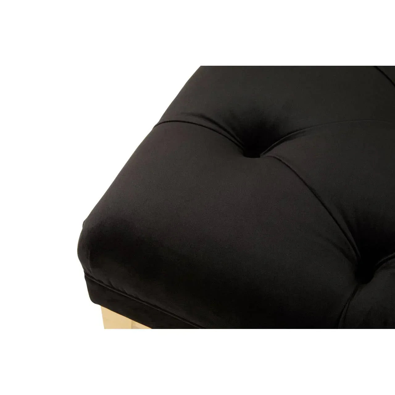 Close-up of black upholstered sofa cushion with button tufting