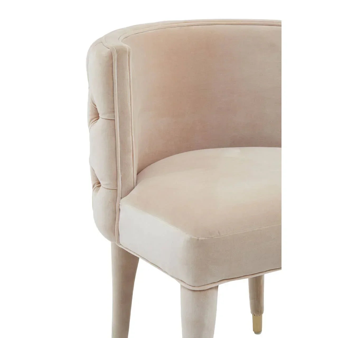 Cream velvet accent chair with curved backrest and gold metal leg detail, close side view