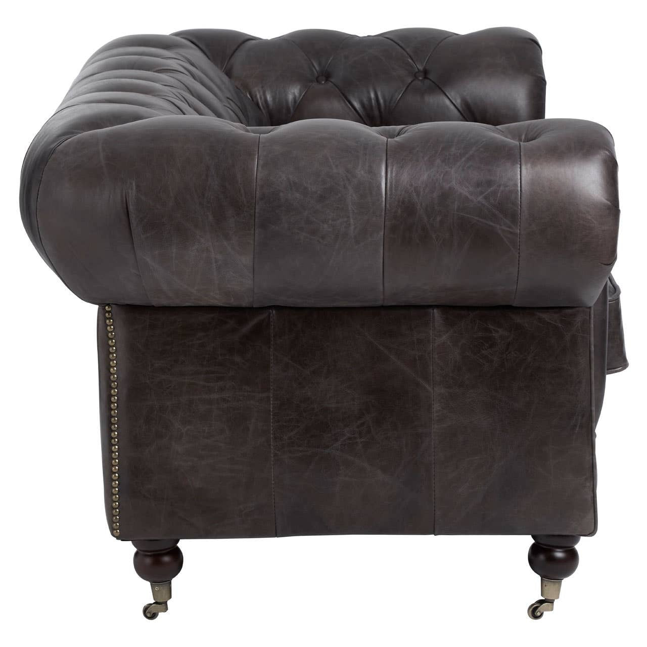 Dark grey brown leather Chesterfield 2 seat sofa featuring a tufted backrest and rolled arms, supported by wooden legs with casters for mobility. The upholstery has a rich texture, highlighting the classic design elements of the sofa