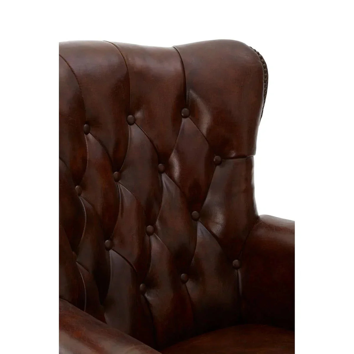 Close-up of brown leather armchair with button-tufted backrest and winged side detail