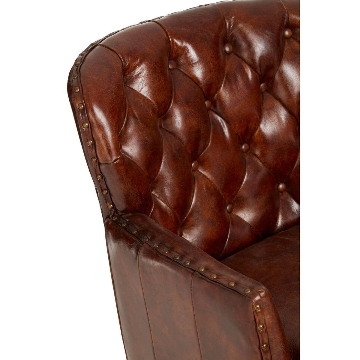 Brown leather armchair with deep button tufting and brass stud detailing