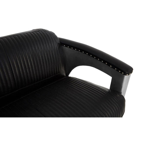 Close-up view of the armrest of a black leather sofa featuring a sleek design with ribbed texture and a cut-out detail for added style