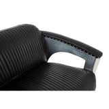 Close-up view of the armrest of a black leather sofa featuring a ribbed texture and a sleek metallic accent. The armrest is designed for comfort and style, showcasing a modern aesthetic