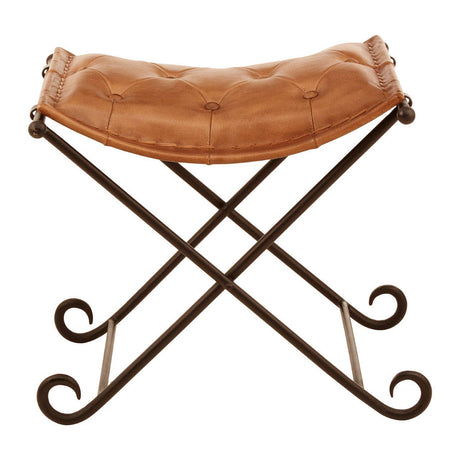 Buffalo brown leather folding stool with a curved seat and a sturdy iron frame featuring decorative scrollwork on the legs, designed for both style and functionality