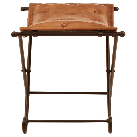 Buffalo brown leather folding stool with a cushioned seat and a sturdy iron frame, featuring a minimalist design and a natural finish. The stool is positioned upright, showcasing its compact and portable structure