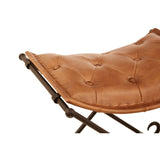 Buffalo brown leather folding stool with a tufted seat and a sturdy iron frame, showcasing a sleek design that combines comfort and style. The stool is partially folded, highlighting its compactness and versatility for various spaces