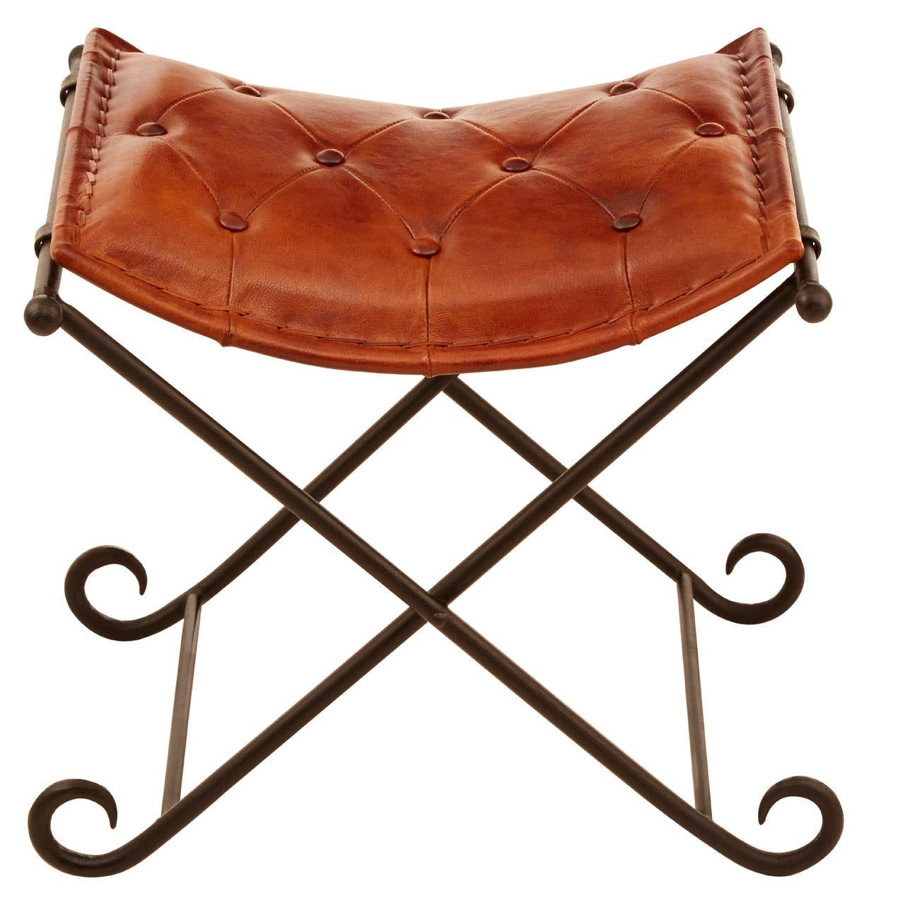 Buffalo tan leather folding stool with a curved seat featuring button tufting, supported by a decorative iron frame with scroll details and an X-shaped base