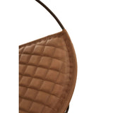 Closeup of brown quilted leather chair backrest with visible stitching and metal frame