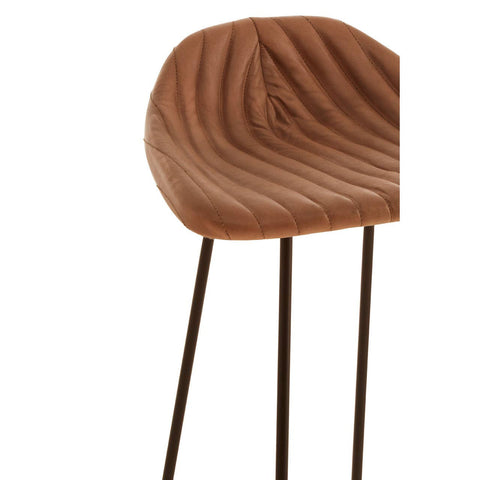 Light brown leather bar stool featuring a curved, textured seat with vertical grooves and a metal footrest, supported by slender black legs