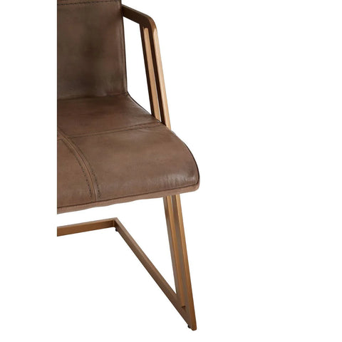 Brown leather dining chair with metal frame and angled legs, partial side view