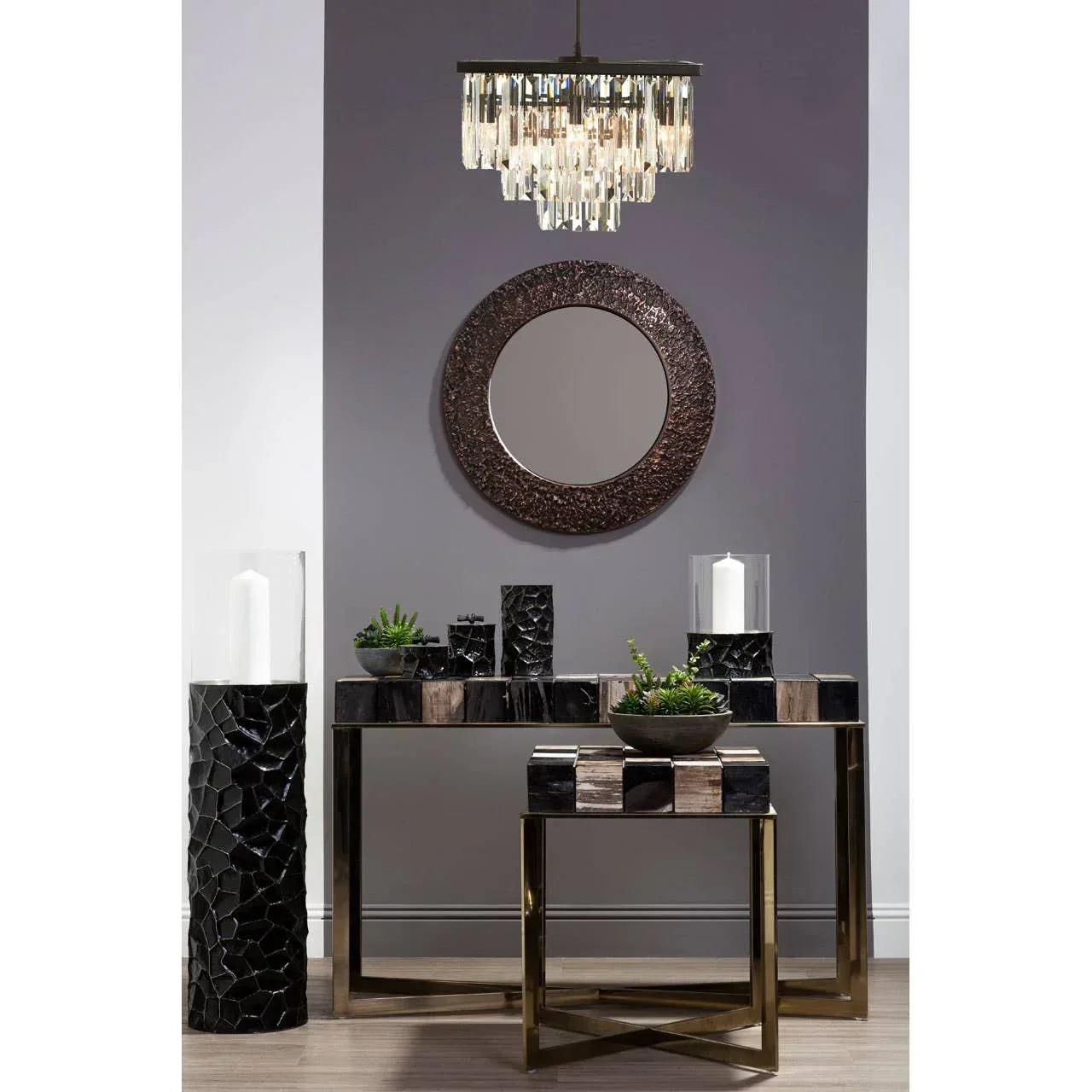 Modern console tables with mosaic black decor, round mirror and chandelier in hallway setting