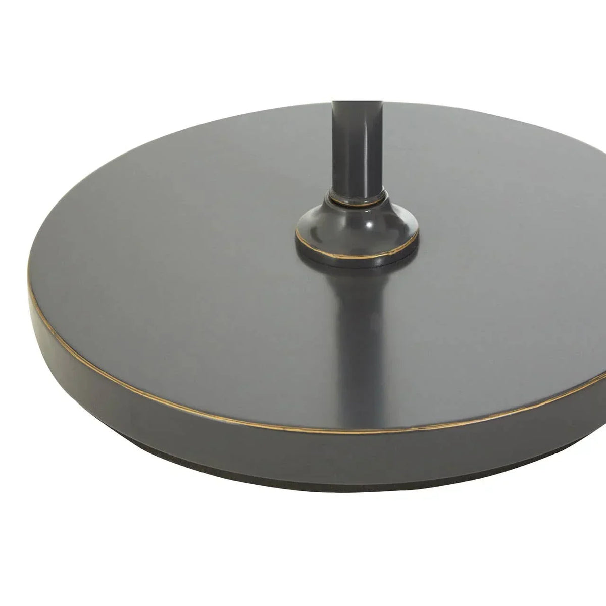 Round metal table base in matte black with gold trim detail, close-up view