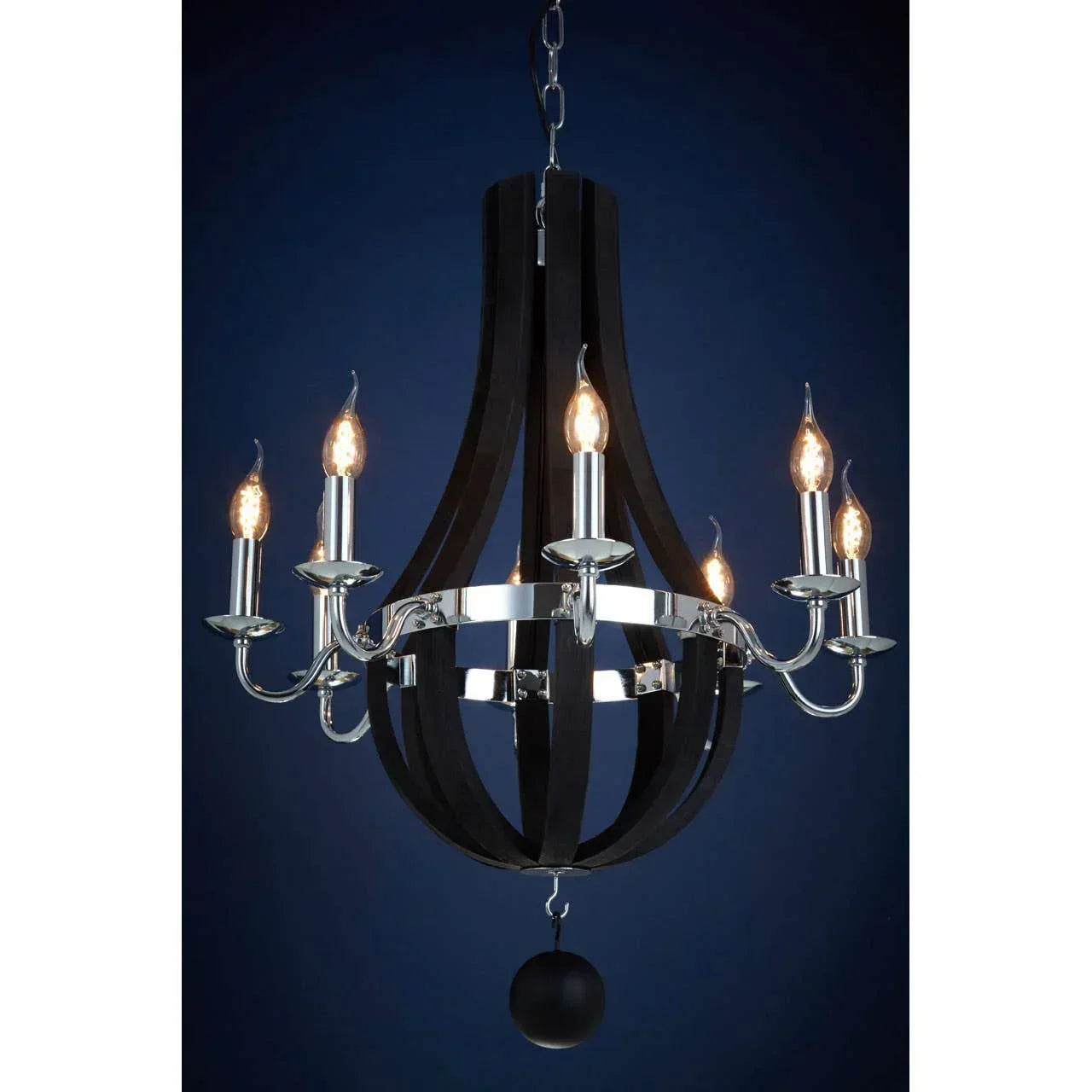 Black and chrome chandelier with eight candle-style lights against dark background