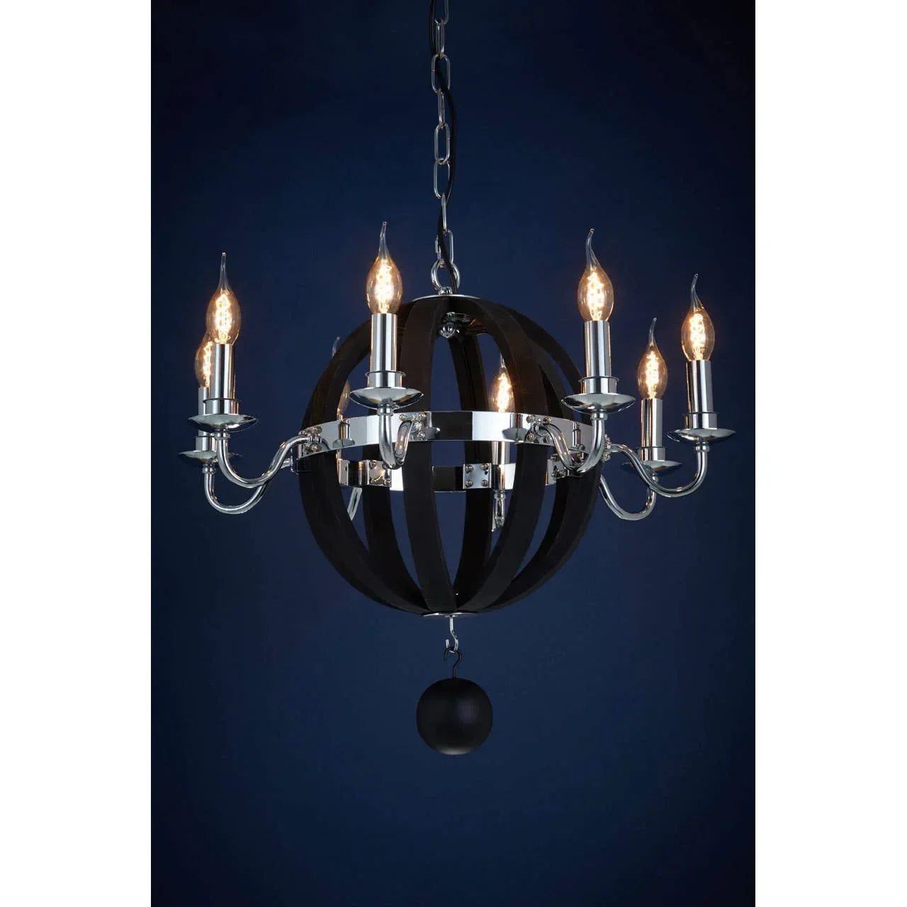 chrome and black chandelier with six candle bulbs and round metal frame on dark background
