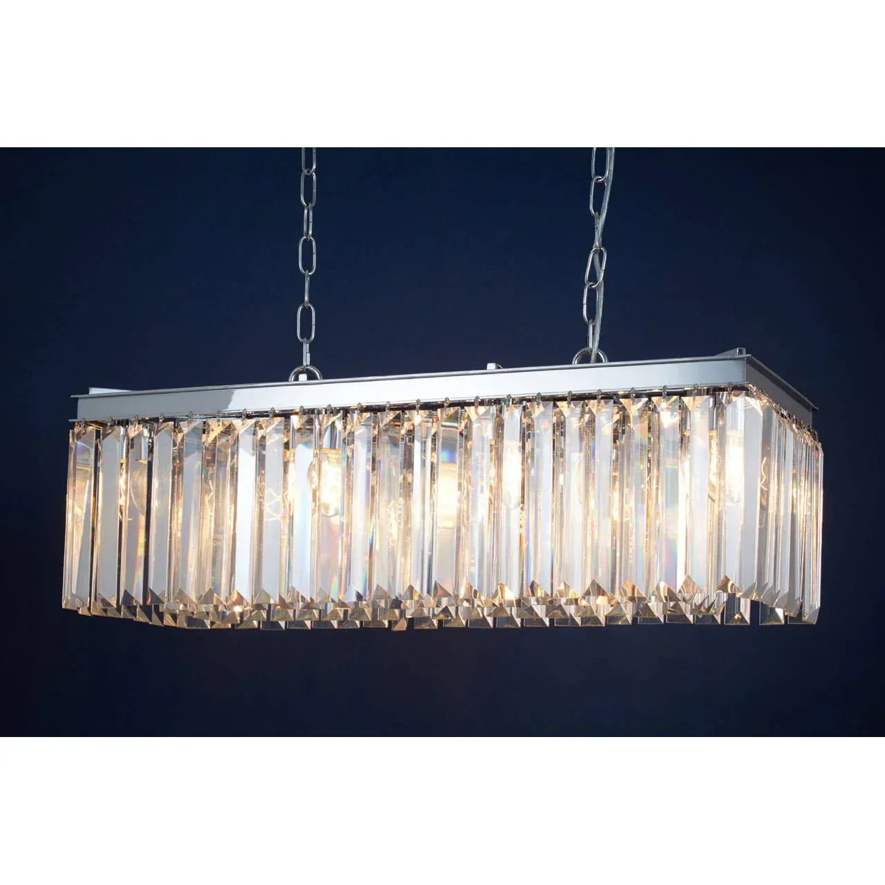 Rectangular crystal chandelier with chrome frame and hanging chains against dark background