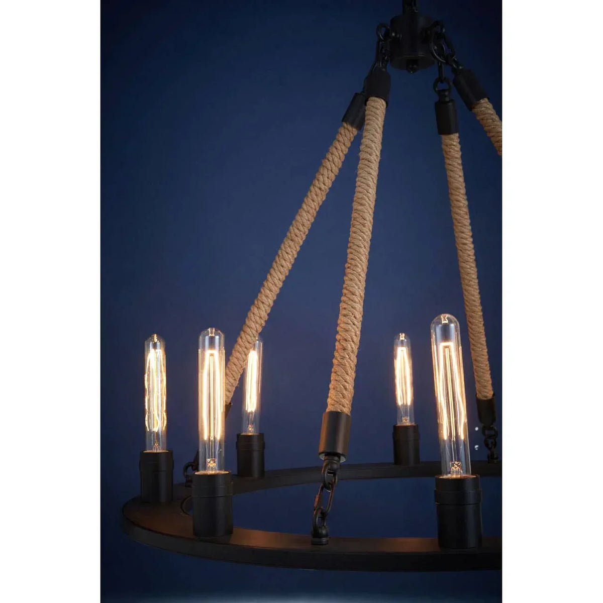 Industrial rope chandelier with exposed filament bulbs against a blue background