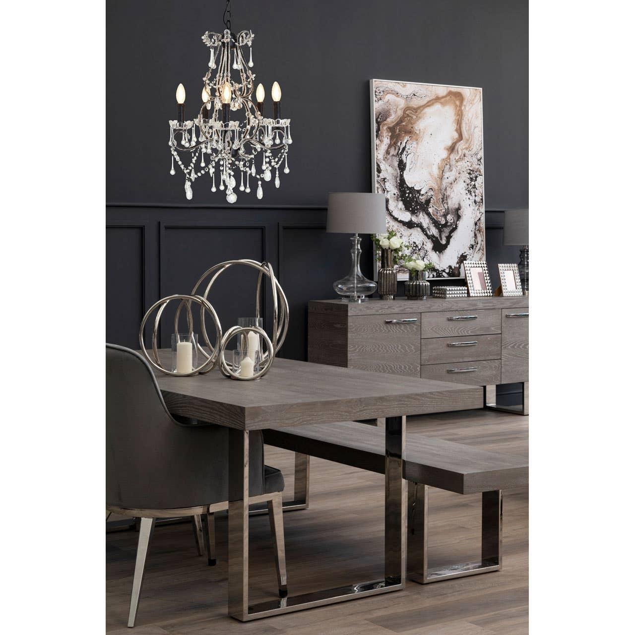 Contemporary grey dining table set with metal legs, matching bench and sideboard in modern room