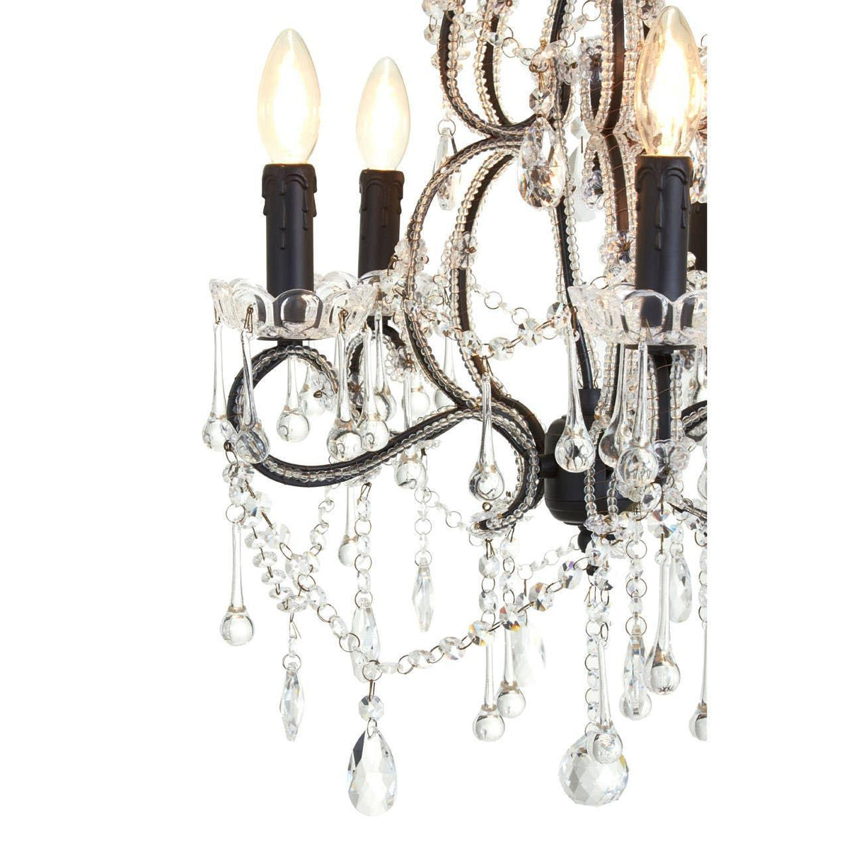 Crystal chandelier detail with black arms, glass droplets, and candle-style bulbs