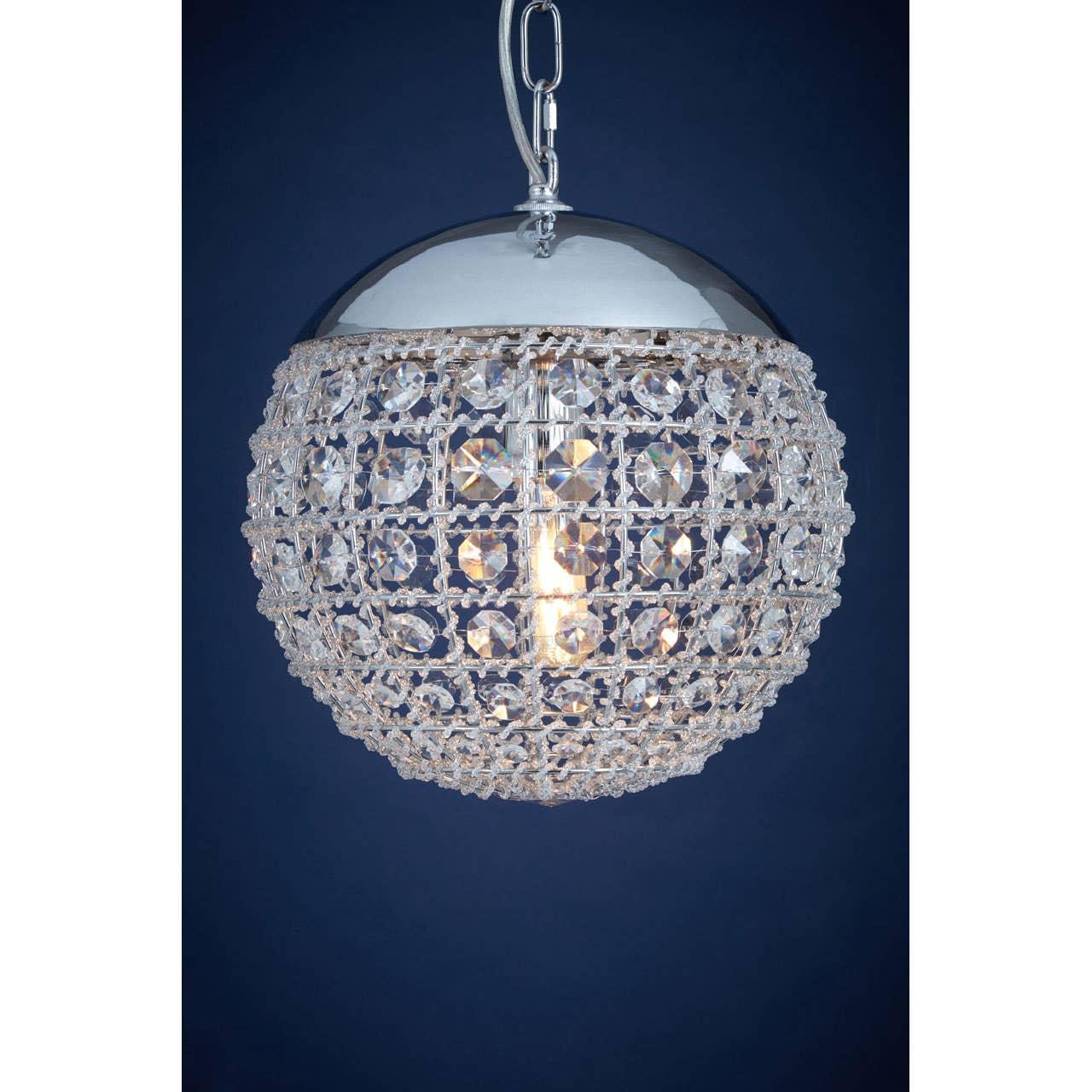 Crystal globe pendant light with chrome top hanging against dark blue background