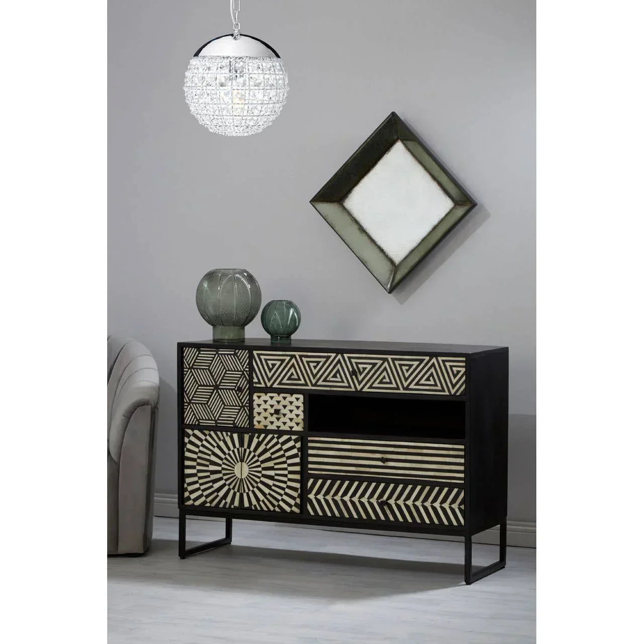 Black patterned sideboard with geometric drawers in modern living room setting