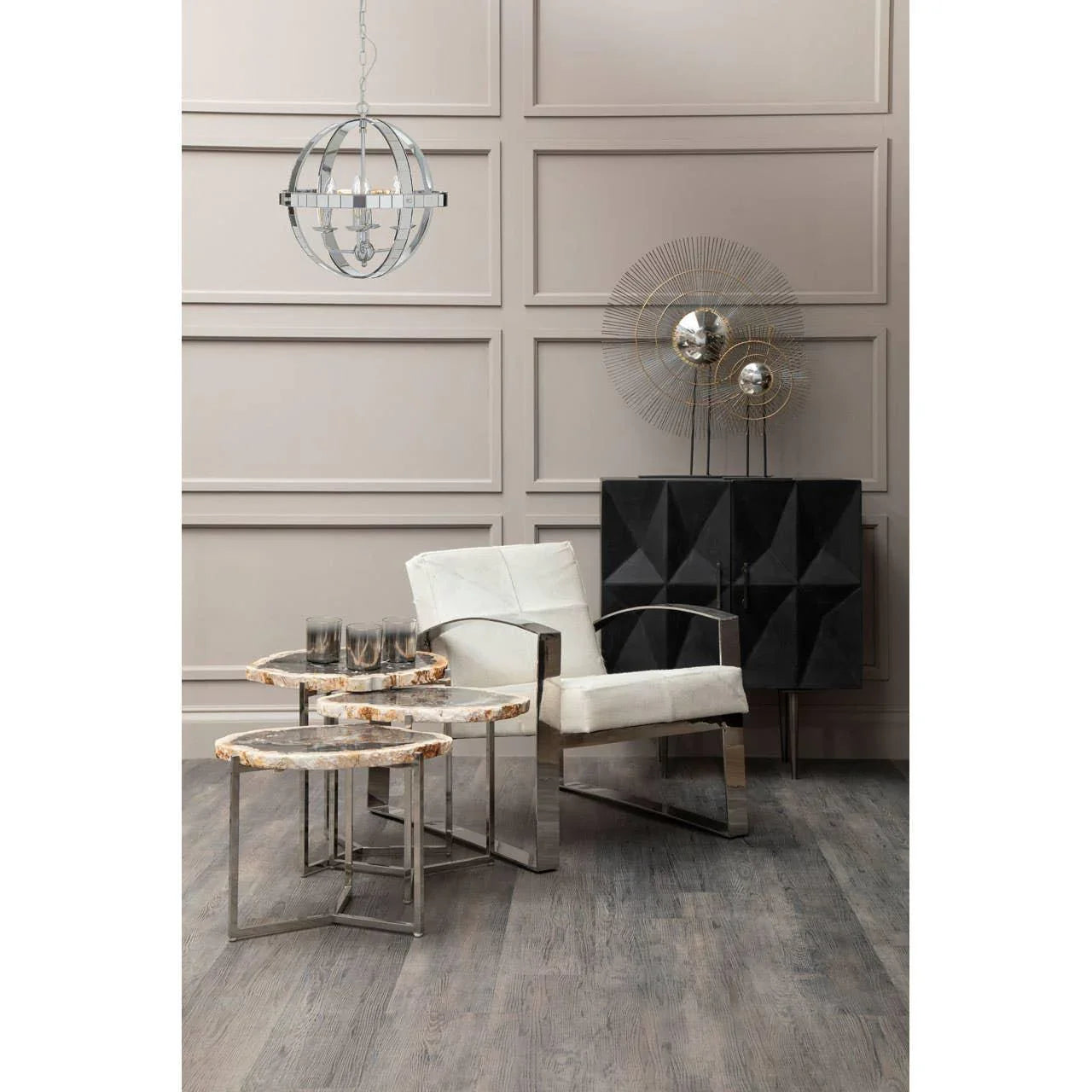 Modern marble and metal nesting tables beside white armchair in contemporary living room