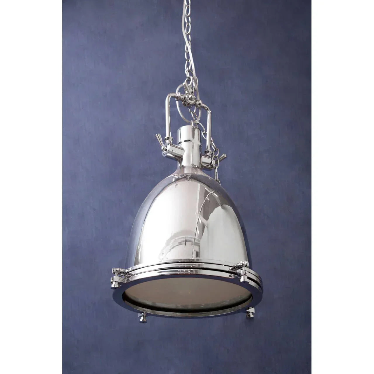Polished chrome pendant light with industrial dome shade and chain hanging against blue wall