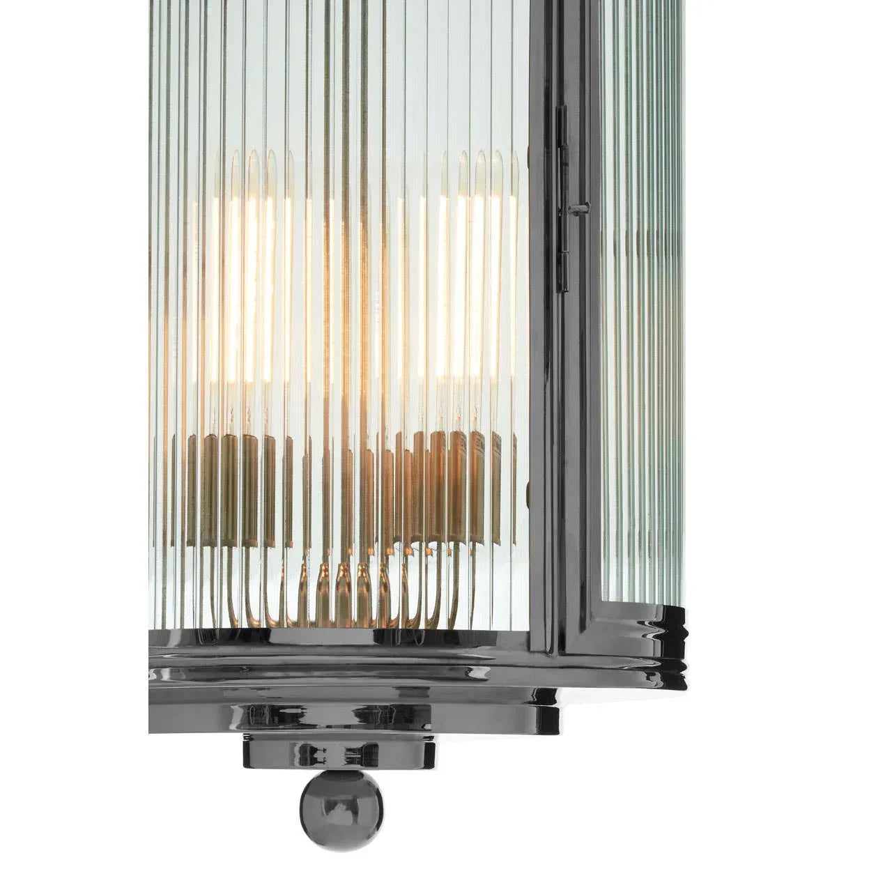 Close up of ribbed glass wall light with chrome frame and exposed bulbs