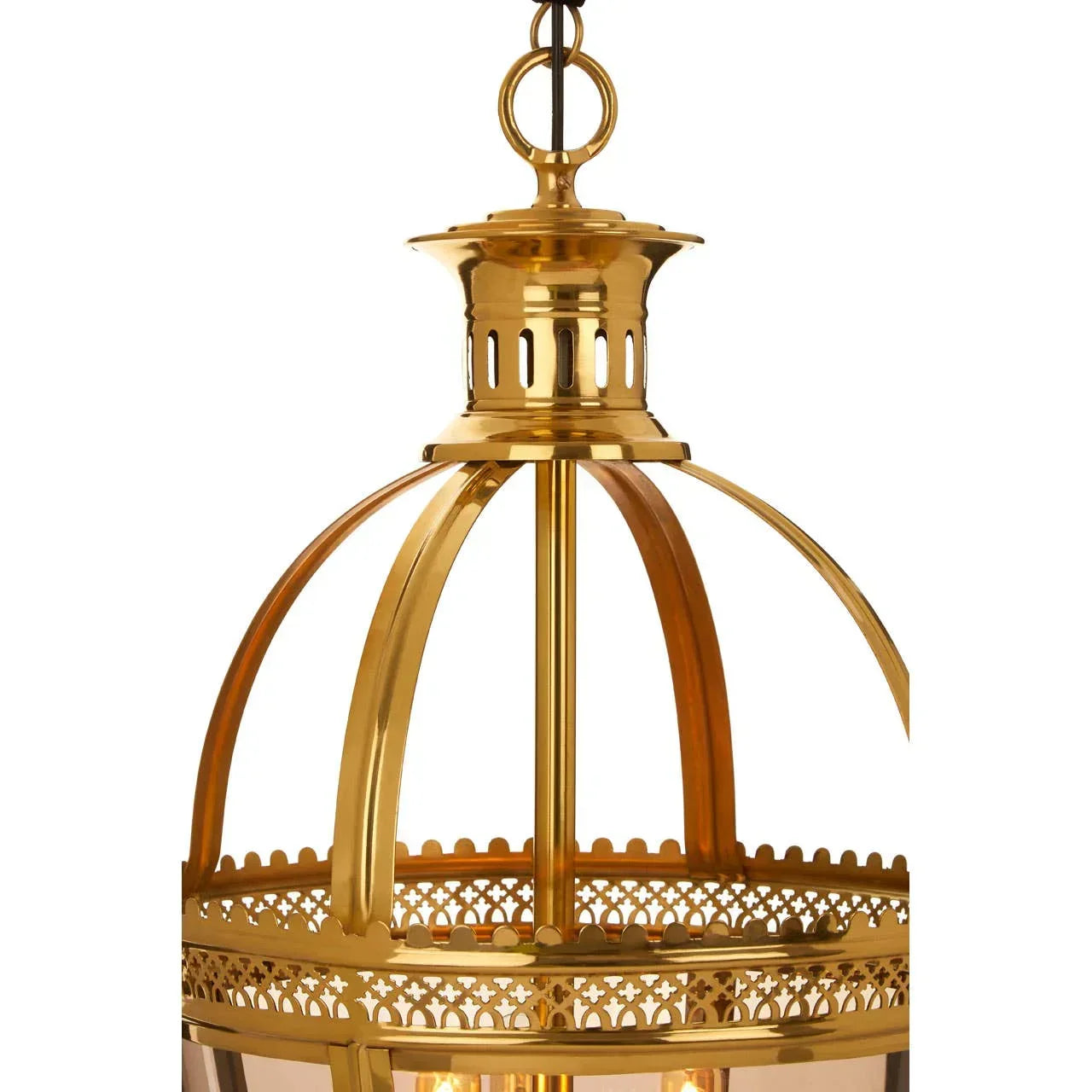 Closeup brass pendant light with curved metal frame and decorative cutout pattern