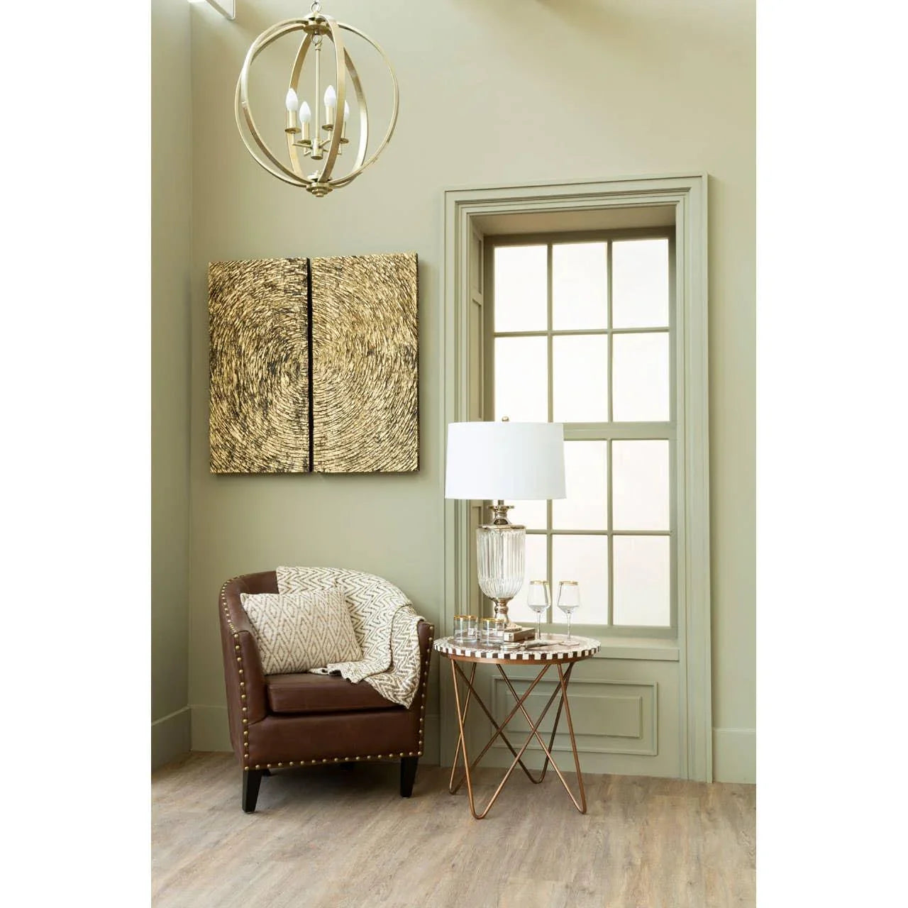 Brown accent chair with stud detailing beside round side table and glass lamp in cozy corner