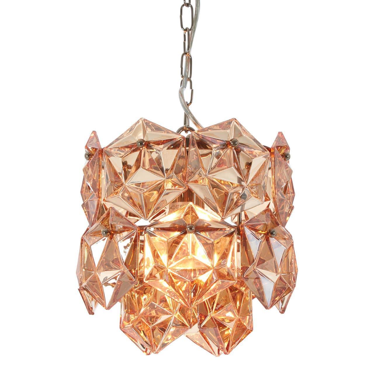 Amber glass pendant light with faceted geometric panels and metal chain hanging fixture
