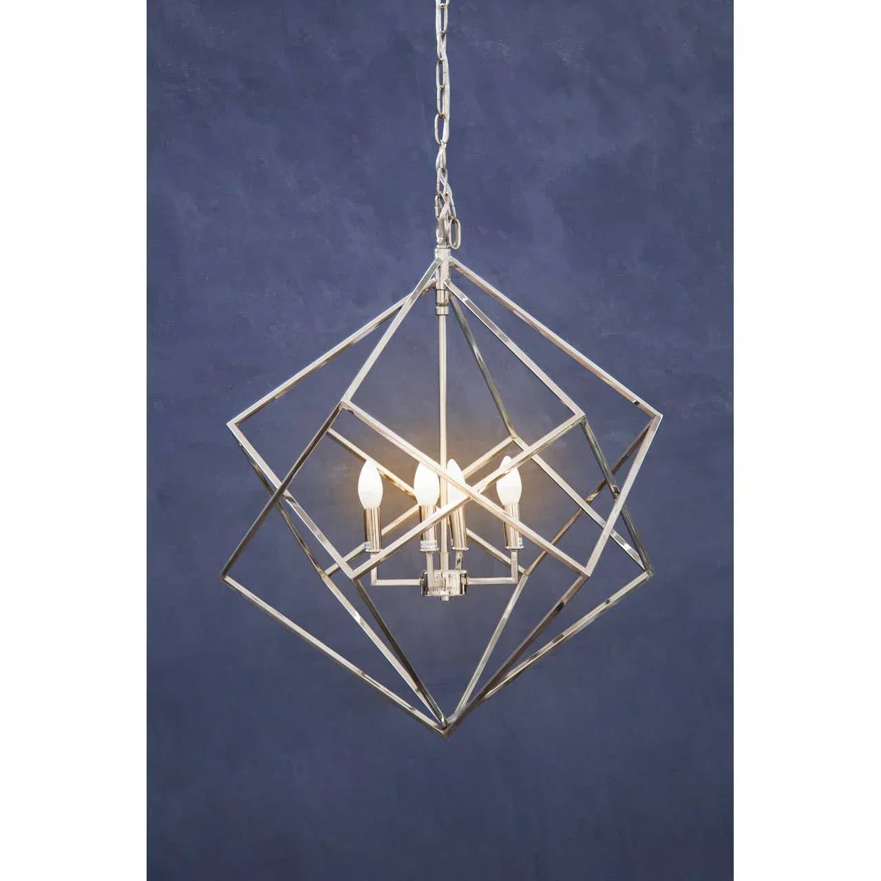 Geometric metal pendant ceiling light with exposed bulbs against blue background
