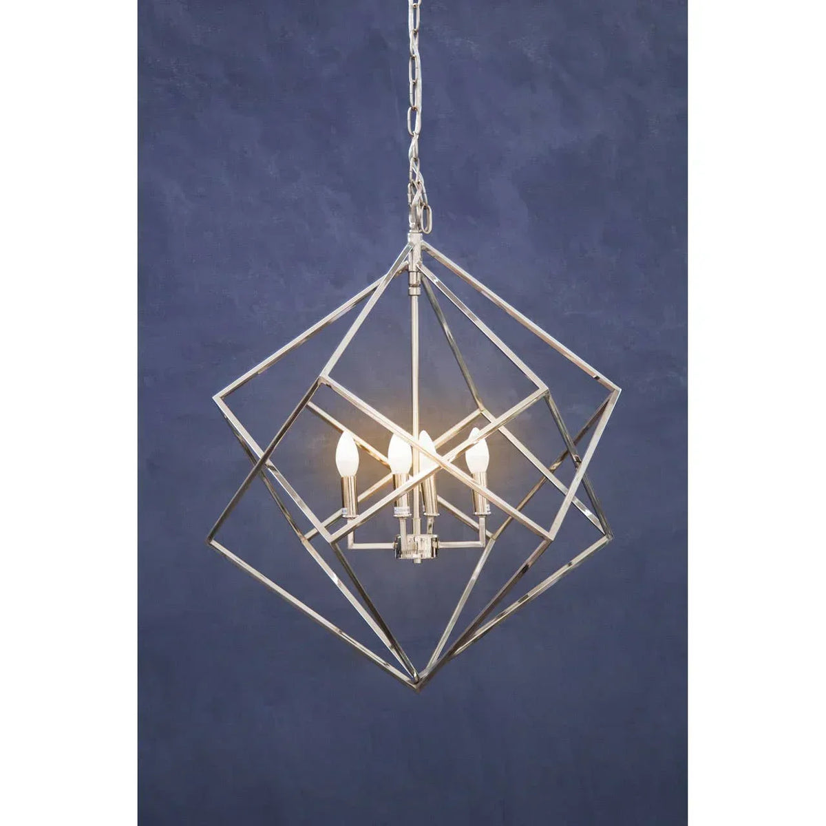 Geometric metal pendant ceiling light with exposed bulbs against blue background