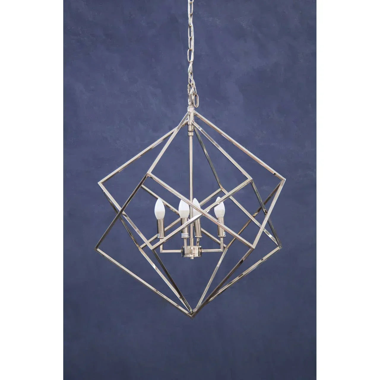 modern geometric pendant light with chrome frame and four bulbs against blue background