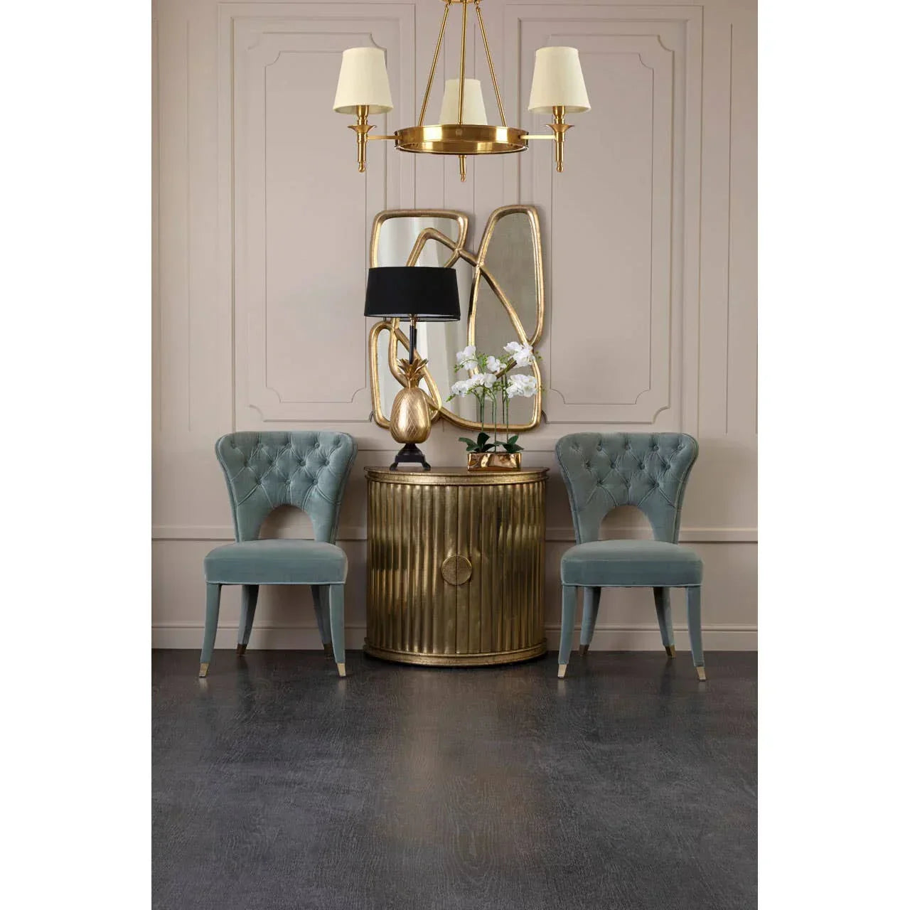 Pair of blue velvet accent chairs and gold console table with mirrors in elegant living room