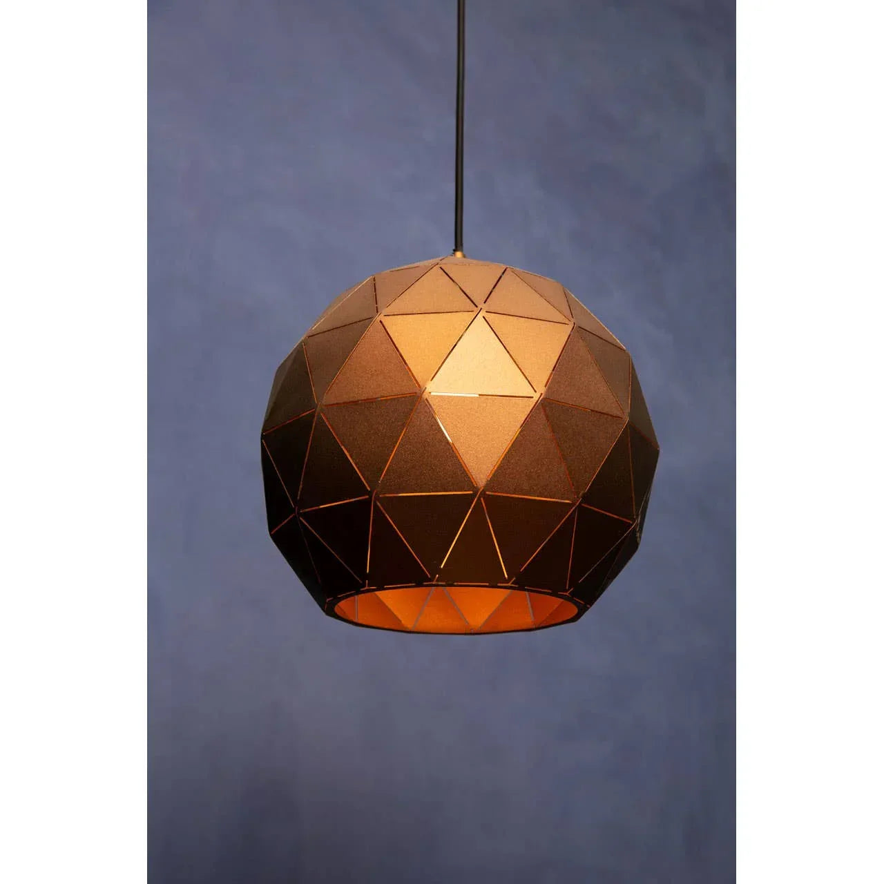 Geometric pendant light with brown metal shade and cut-out pattern against blue background