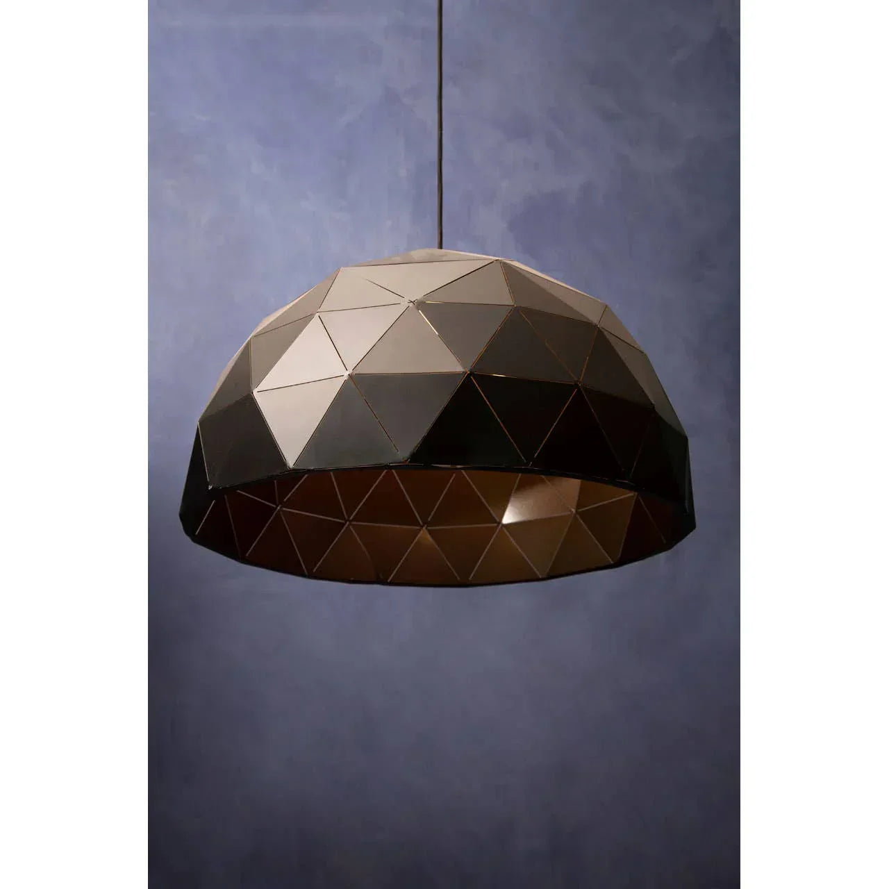 Geometric dome pendant light with black and bronze metal finish against blue background