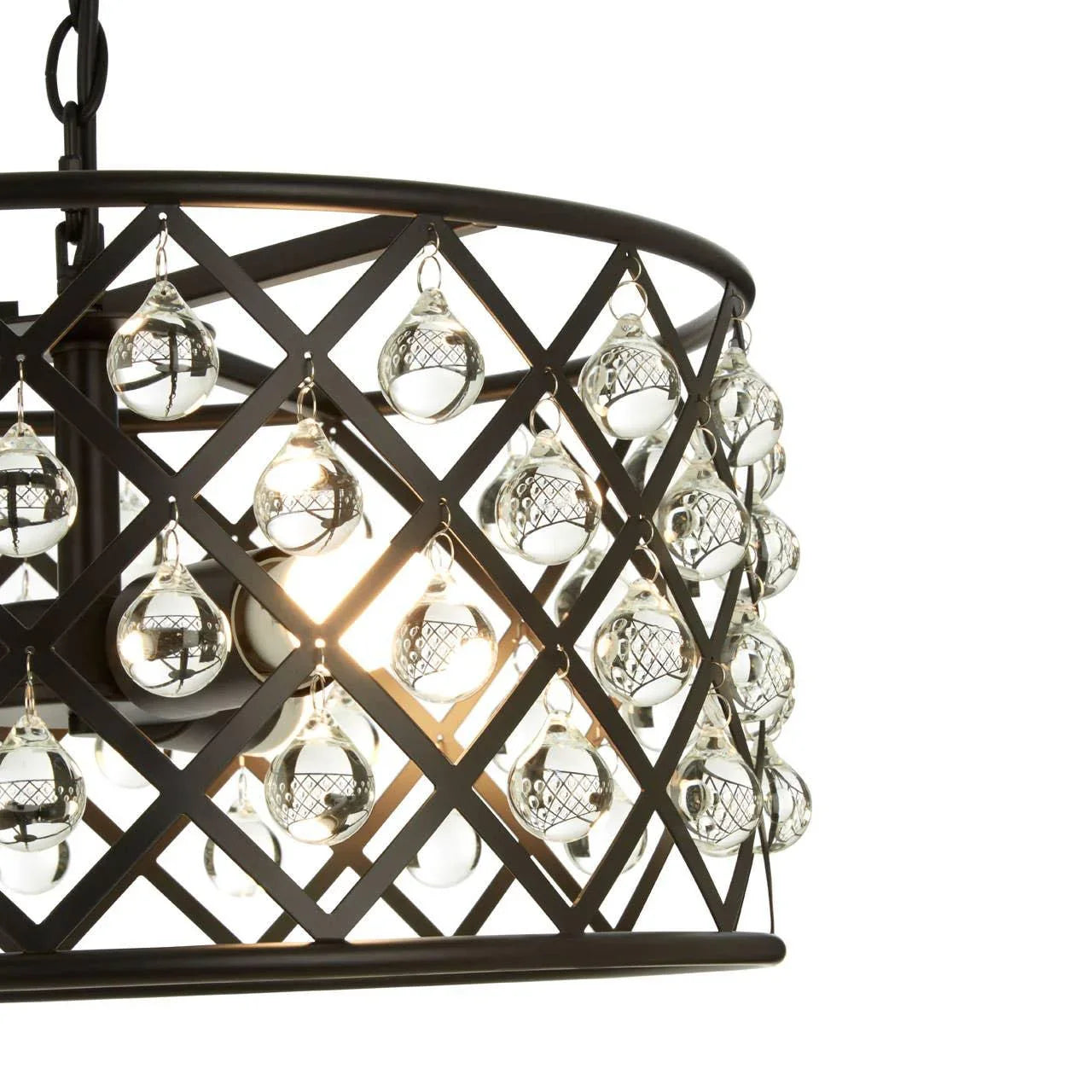 Crystal pendant light with lattice frame and glass droplets, illuminated, close-up view