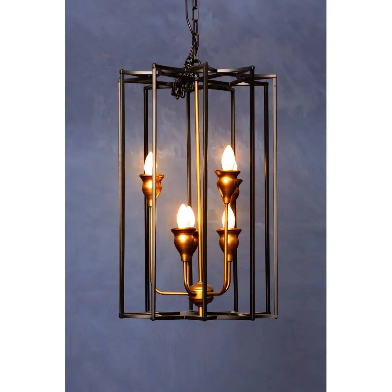 Brass and black metal pendant light with four candle-style bulbs in open cage frame