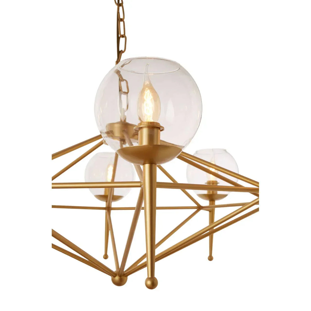 Gold chandelier with clear glass globe shades and candle-style bulbs, close view