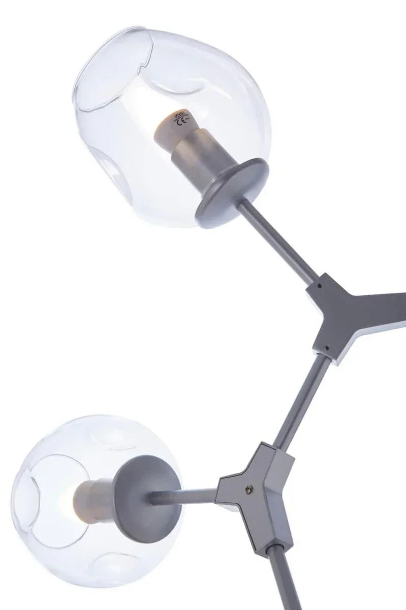 Modern floor lamp with brushed metal arms and two clear glass globe shades