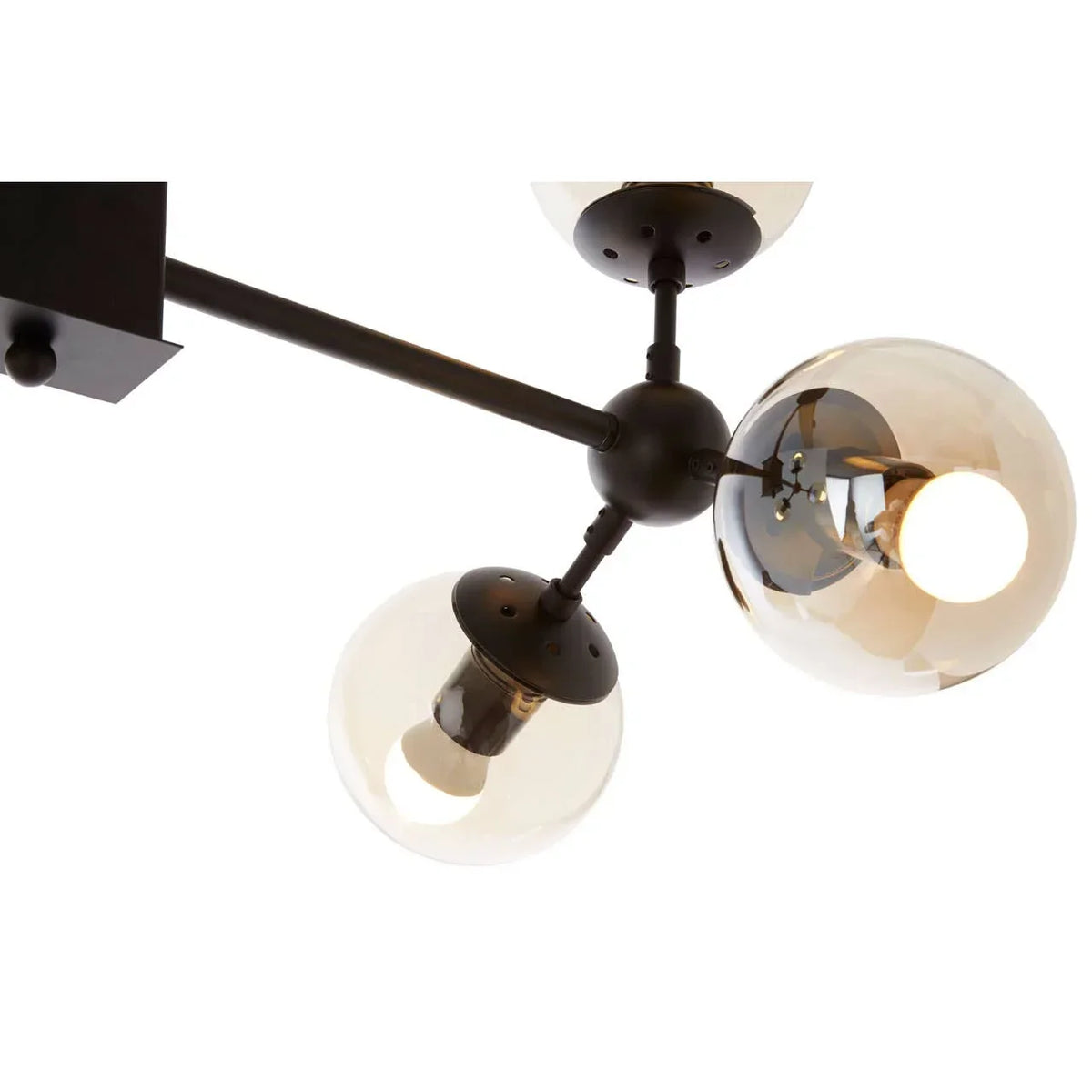 Modern ceiling light fixture with three smoked glass globe shades and black metal arms
