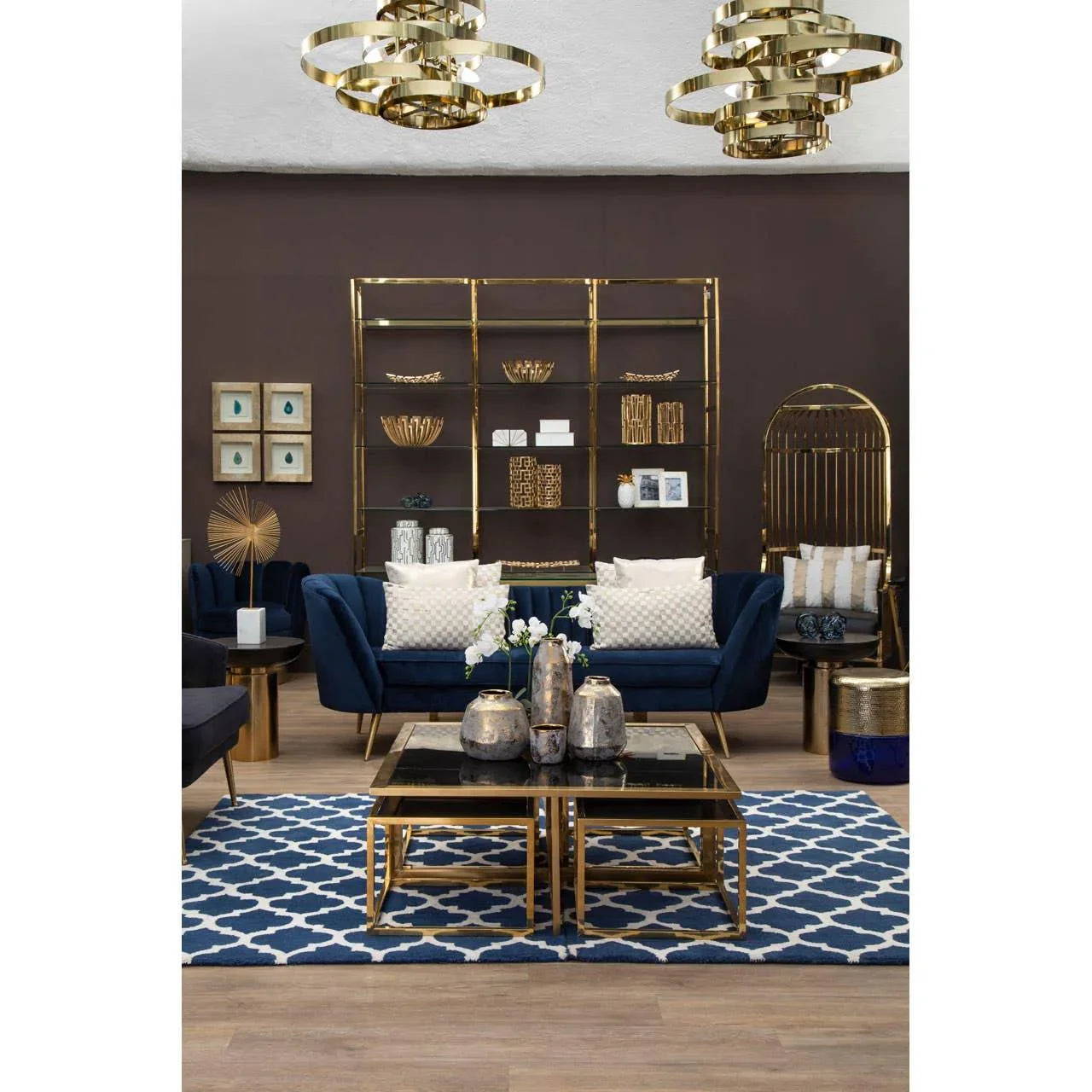 Velvet navy sofa with gold frame coffee table and geometric rug in modern living room