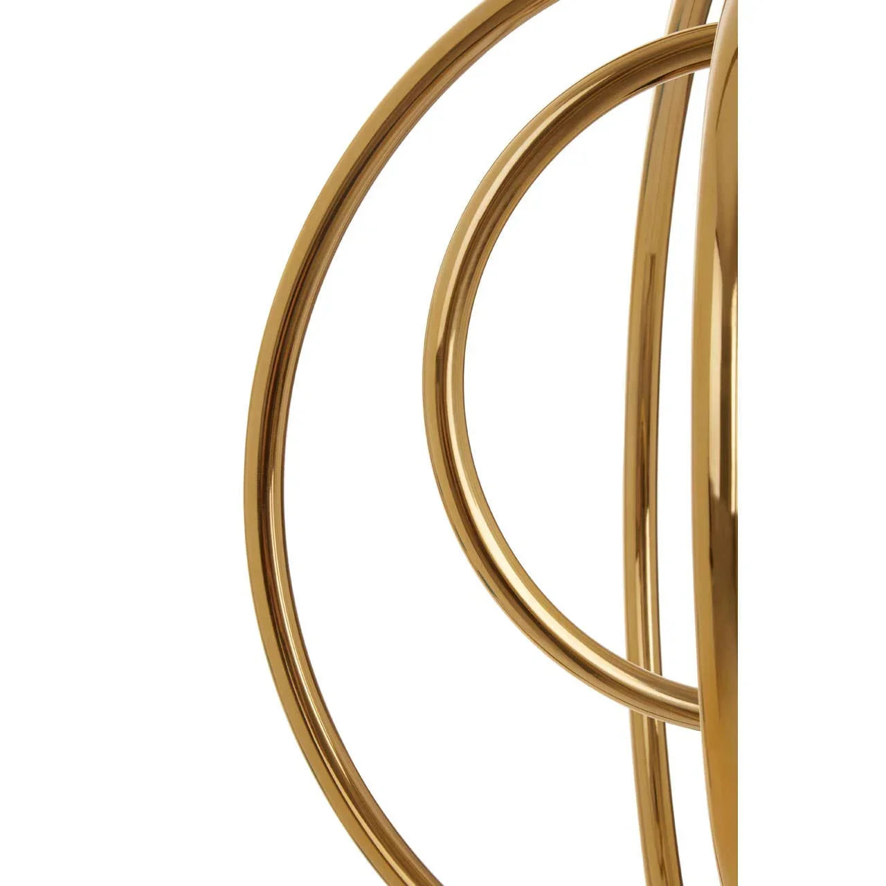 Gold metal table base with curved rings, close-up of modern furniture detail