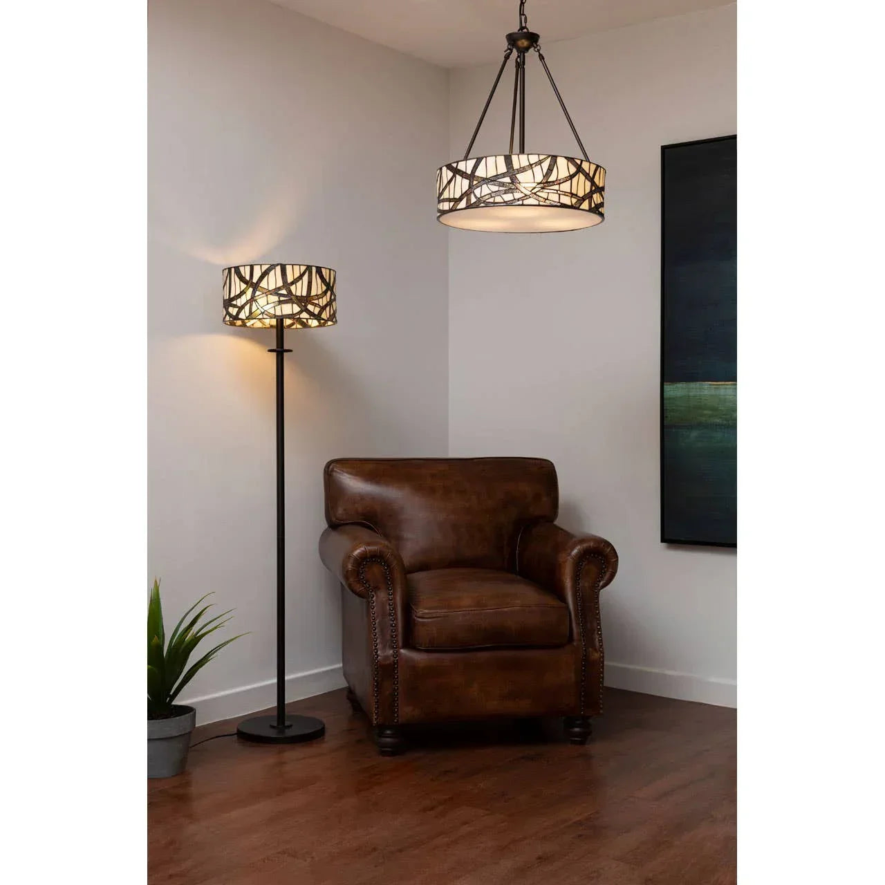 Brown leather armchair with floor and ceiling lamps in modern living room corner