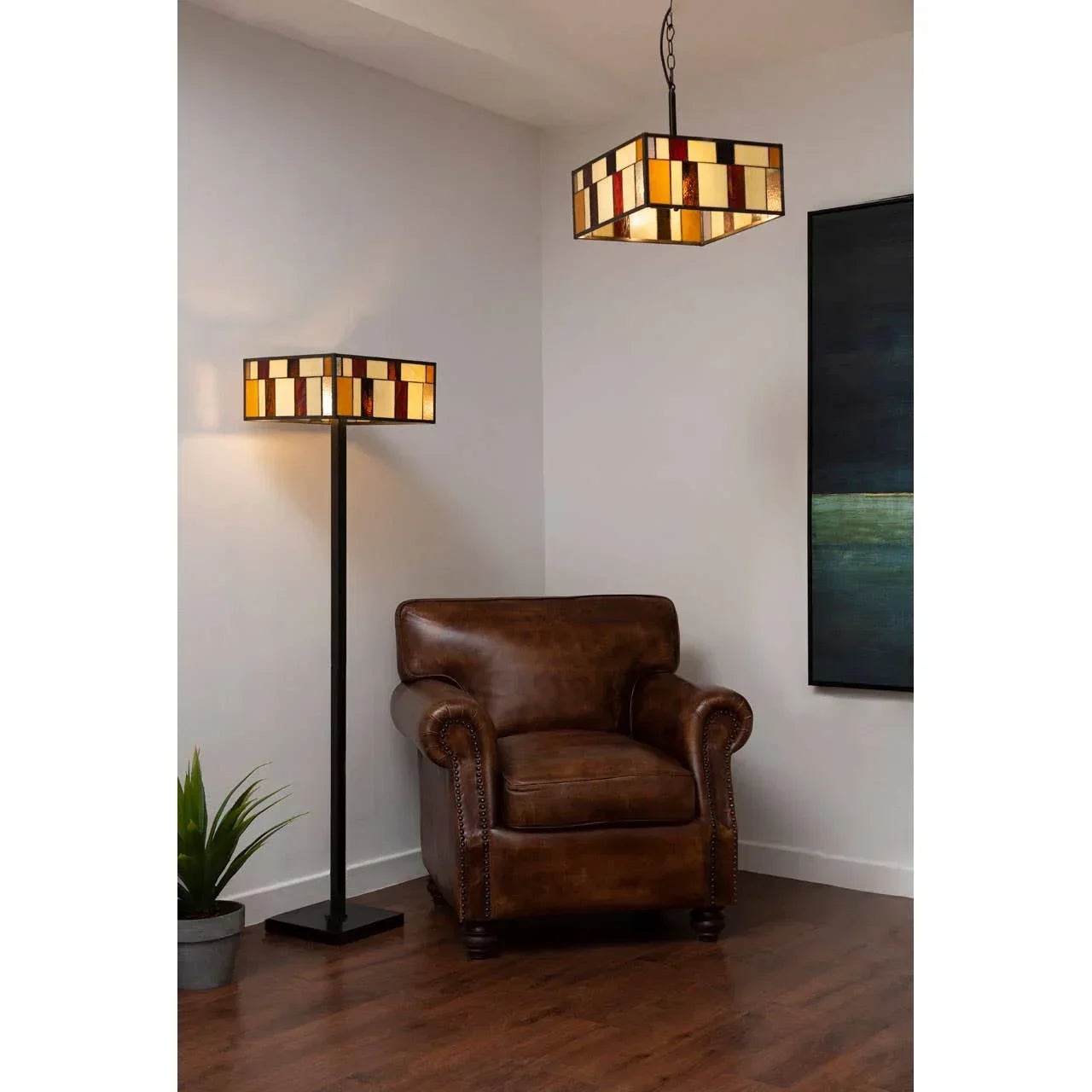 Brown leather armchair with stained glass floor lamp and pendant in a modern living room