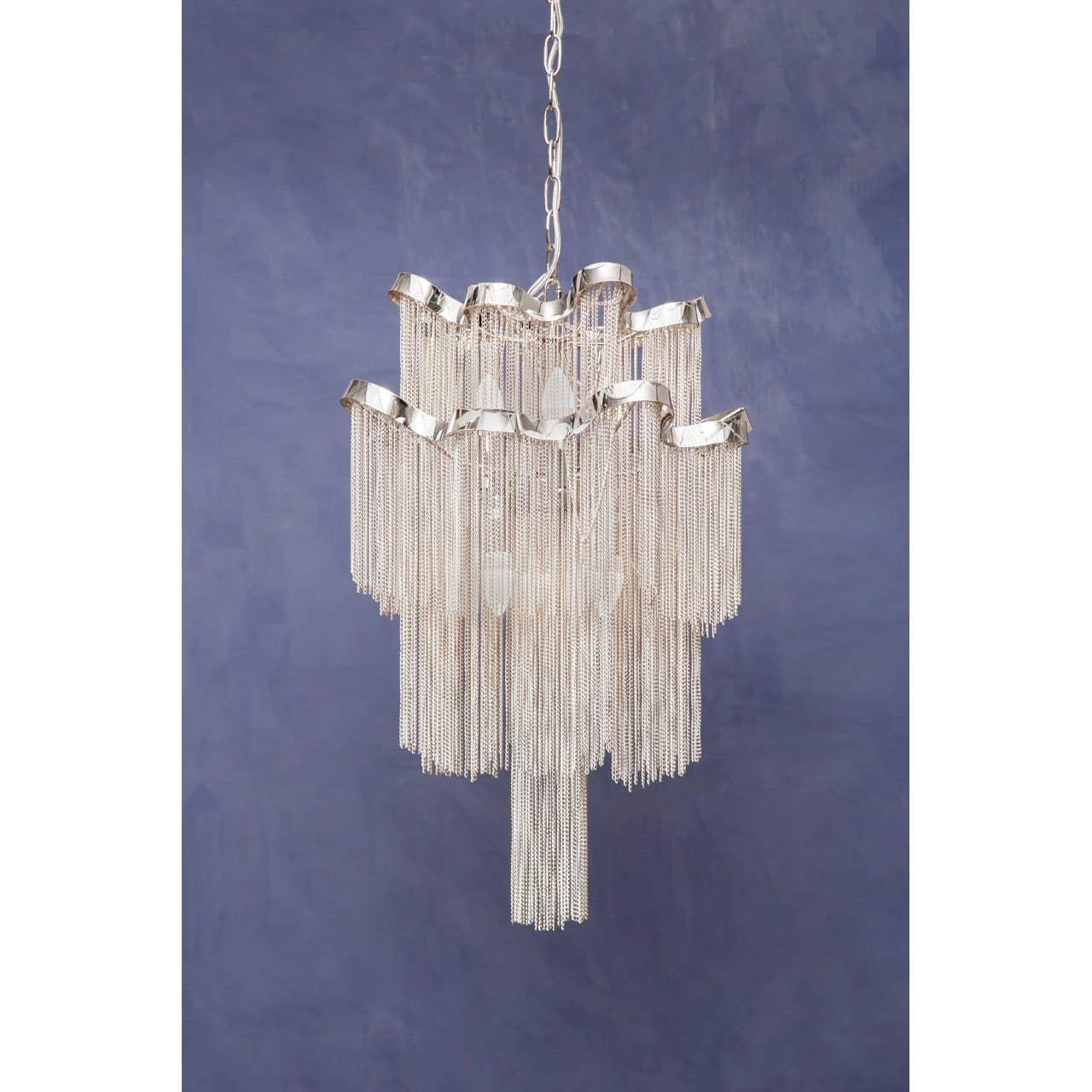 Silver chain chandelier with layered tiers and modern design against blue background