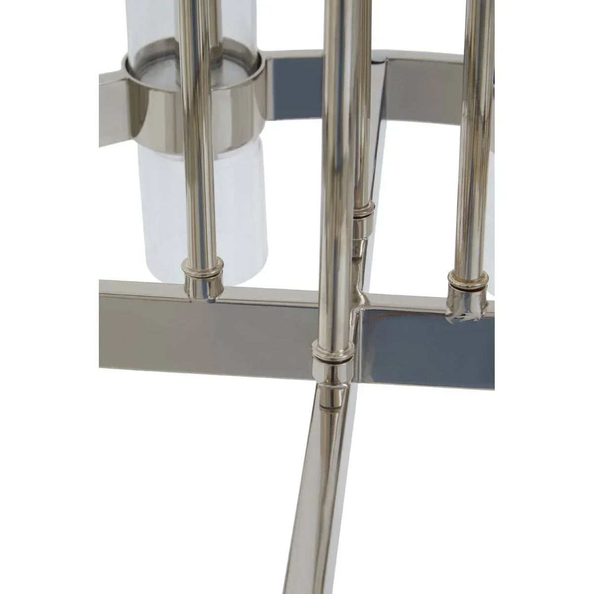 Close-up of chrome lamp base with metal rods and glass cylinder detail