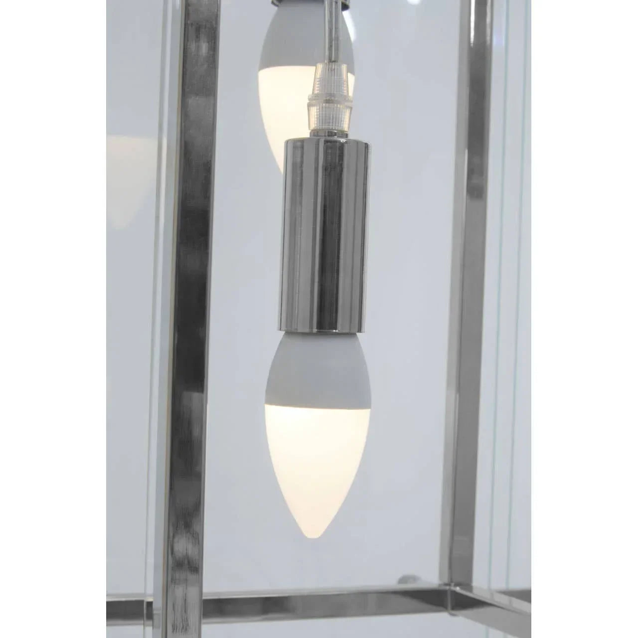 Close-up of chrome pendant light fitting with frosted bulb and glass panels