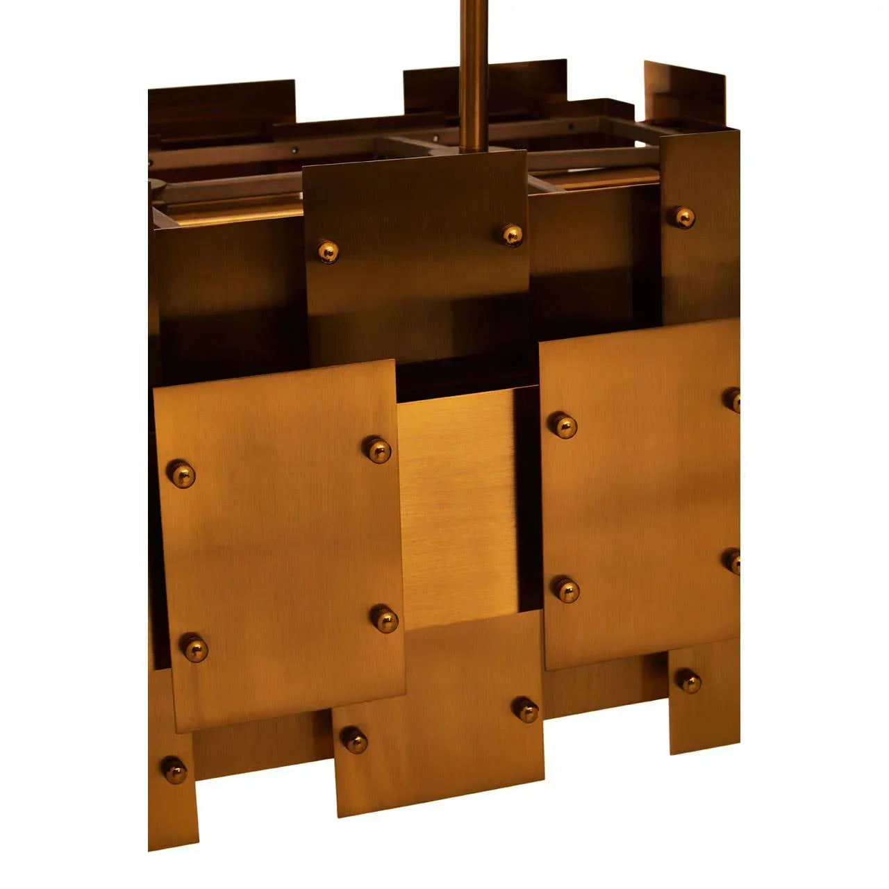 Close-up of geometric brass pendant light fixture with layered metal panels