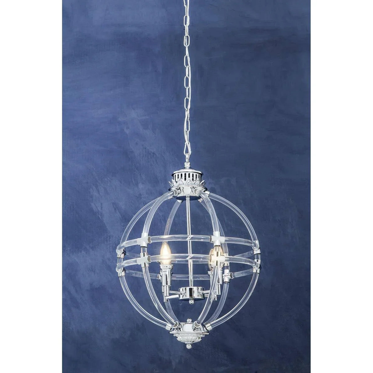 Chrome and glass globe pendant light with three candle bulbs against blue wall